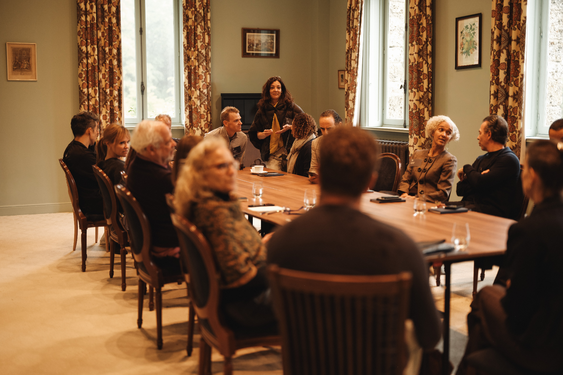 Odyssey guests gathered around a table in a warm roundtable discussion.