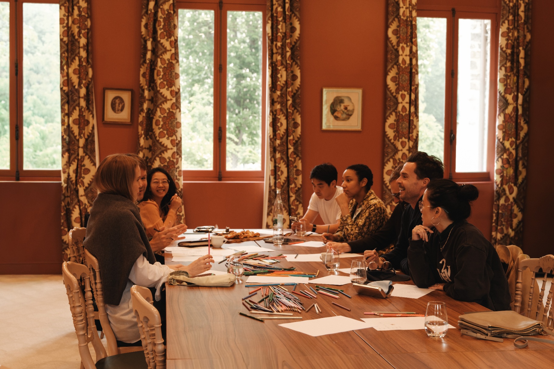 A small Odyssey workshop with drawing materials around a table.
